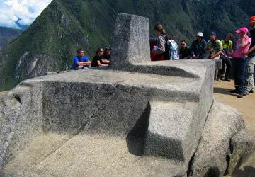 Tourists studying the Intihuatana solar clock at Machu Picch
