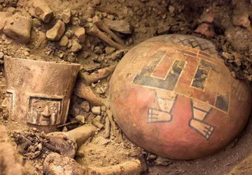 Carved alabaster cup and a flask with painted Wari Lord