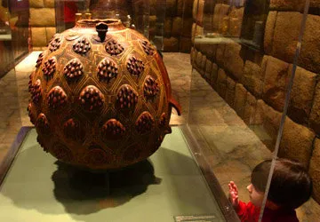 Observing one of the Machu Picchu pieces in Cusco