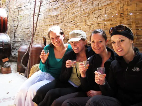 Group of travelers sampling Piscos in Ica, Peru.