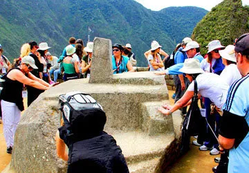 Touching the Intihuatana Solar Clock in Machu Picchu