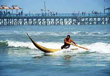 Riding the waves in a caballo de totora in coastal Peru.