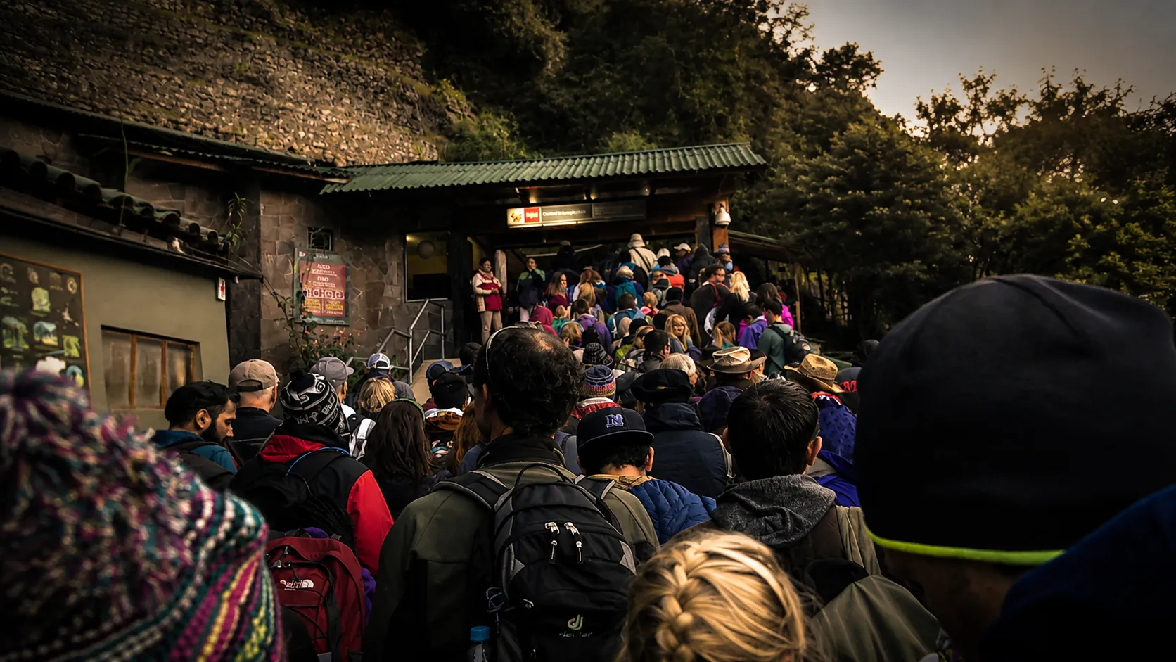 Control staff checking tourists' documents at the entrance to Machu Picchu