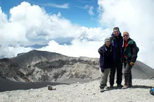 Three hikers in front of the rim of El Misti Volcano's crate
