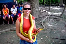 Youn woman with snake in the Bolivia marshlands near Rurrena