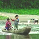 Young boys on raft in the Tacana community in the Bolivia ju