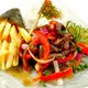 Traditional plate of Lomo Saltado during dinner show in Lima