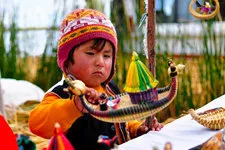 Girl with totora reed souvenier on Uros Island in Lake Titic