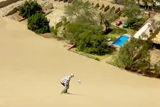 Sandboarding by Huacachina Oasis in Ica region near Nazca, P